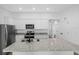 Granite countertops and stainless steel appliances highlight this open concept kitchen at 15098 Chimney Swift Rd, Brooksville, FL 34614
