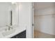 View of a bathroom vanity and a glimpse into the adjacent walk-in closet at 1530 W River Shore Way, Tampa, FL 33603