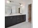 Modern bathroom featuring a double vanity, large mirror, and walk-in closet access at 1530 W River Shore Way, Tampa, FL 33603