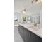 Modern bathroom with double vanity, large mirror, and tiled floor at 1530 W River Shore Way, Tampa, FL 33603