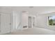 Bright, carpeted bedroom with white walls and multiple doors at 1530 W River Shore Way, Tampa, FL 33603