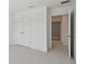 Empty bedroom featuring plush carpeting and a double door closet at 1530 W River Shore Way, Tampa, FL 33603