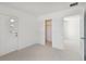 Bright white bedroom with a door and an open closet at 1530 W River Shore Way, Tampa, FL 33603