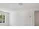 Simple, spacious bedroom with large window and white walls at 1530 W River Shore Way, Tampa, FL 33603