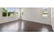 Spacious, empty room with multiple windows and dark wood flooring at 1530 W River Shore Way, Tampa, FL 33603