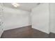 View of the entryway's dark wood floors, white walls, and simple ceiling light at 1530 W River Shore Way, Tampa, FL 33603