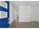 Bright entryway with a bold blue door, modern wood floors, and white walls at 1530 W River Shore Way, Tampa, FL 33603