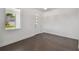 View of the entryway with white door, a large window, dark wood floors, and white walls at 1530 W River Shore Way, Tampa, FL 33603