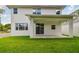Back exterior view showcasing patio, backyard and white siding at 1530 W River Shore Way, Tampa, FL 33603