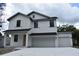 Charming two-story home featuring a double garage and a classic white exterior at 1530 W River Shore Way, Tampa, FL 33603