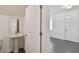 Half bathroom with a pedestal sink, mirror, toilet, and view of the home's entryway at 1530 W River Shore Way, Tampa, FL 33603