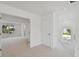Hallway leading to a bedroom with carpeted floors and natural light at 1530 W River Shore Way, Tampa, FL 33603