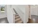 Clean and bright hallway featuring carpeted stairs and elegant, light-colored walls at 1530 W River Shore Way, Tampa, FL 33603