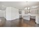 Open-concept kitchen and dining area with gray cabinets, island, and wood floors at 1530 W River Shore Way, Tampa, FL 33603