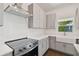 Modern kitchen with gray cabinets, stainless steel appliances, and white quartz countertops at 1530 W River Shore Way, Tampa, FL 33603