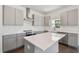 Modern kitchen with island, stainless steel appliances, and sleek gray cabinetry at 1530 W River Shore Way, Tampa, FL 33603