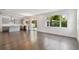 Open concept kitchen and dining area with gray shaker cabinets, stainless steel appliances, and wood-look flooring at 1530 W River Shore Way, Tampa, FL 33603