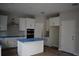Modern kitchen with stainless steel appliances, sleek white cabinets, and a functional island at 1530 W River Shore Way, Tampa, FL 33603
