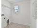 Laundry room with wire shelving, washer/dryer hookups, and window at 1530 W River Shore Way, Tampa, FL 33603