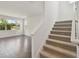 Stairway with carpeted steps and a simple white railing, leading to the upper floor at 1530 W River Shore Way, Tampa, FL 33603