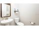 Clean and simple bathroom with a pedestal sink and toilet at 16831 Banner Shell Pl, Wimauma, FL 33598
