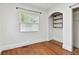 Bedroom featuring hardwood floors, built-in shelves and a window at 2230 6Th N Ave, St Petersburg, FL 33713