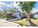 Cute bungalow with a stone path, well-maintained lawn, and mature tree in front at 2230 6Th N Ave, St Petersburg, FL 33713