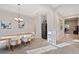 Dining room with wood table and wine cooler, offering views into the home at 29177 Picana Ln, Wesley Chapel, FL 33543