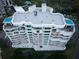 Aerial view of a luxury condo building with multiple balconies and a pool at 3 Seaside Ln # 601, Belleair, FL 33756