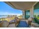 Balcony with wicker seating and a blue rug provides a relaxing space with an expansive ocean view at 3 Seaside Ln # 601, Belleair, FL 33756