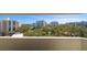 Balcony with view of lush landscaping and neighboring buildings at 3 Seaside Ln # 601, Belleair, FL 33756