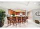 Wet bar with seating, decorative lighting, ample cabinet space, and a great location near living areas at 3 Seaside Ln # 601, Belleair, FL 33756