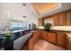 Entertainer's kitchen bar with granite counters, wooden cabinets, and picturesque views of the waterfront at 3 Seaside Ln # 601, Belleair, FL 33756