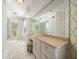 Elegant bathroom with double vanity, large mirror, and patterned wallpaper at 3 Seaside Ln # 601, Belleair, FL 33756