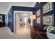 Hallway view of a bathroom with a patterned wall, tiled floors, and a chandelier at 3 Seaside Ln # 601, Belleair, FL 33756
