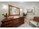Powder room features custom vanity with a vessel sink, framed mirror, and stylish decor at 3 Seaside Ln # 601, Belleair, FL 33756