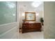 Powder room features custom vanity with a vessel sink, framed mirror, and stylish decor at 3 Seaside Ln # 601, Belleair, FL 33756