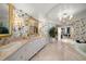 Large bathroom with a soaking tub, double vanity, and marble floors at 3 Seaside Ln # 601, Belleair, FL 33756