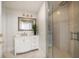 Modern bathroom with white vanity, glass shower, and marble floors at 3 Seaside Ln # 601, Belleair, FL 33756