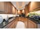 Butler pantry with wood cabinets, granite countertops, and ample storage space at 3 Seaside Ln # 601, Belleair, FL 33756