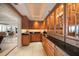 Butler's pantry features illuminated glass-front cabinets, granite counters and elegant marble floors at 3 Seaside Ln # 601, Belleair, FL 33756