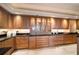 Expansive butler's pantry offers ample storage with granite countertops and lighted glass-front cabinets at 3 Seaside Ln # 601, Belleair, FL 33756
