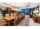 Formal dining room featuring water views, a large table, and a custom buffet and display cabinet at 3 Seaside Ln # 601, Belleair, FL 33756