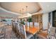 Large dining room with long table, water view, a large china cabinet, and statement lighting at 3 Seaside Ln # 601, Belleair, FL 33756