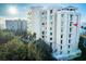 Beautiful multi-story building surrounded by lush trees and greenery at 3 Seaside Ln # 601, Belleair, FL 33756