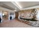 Welcoming hallway with stone wall decor, tiled floor, and elegant entrance at 3 Seaside Ln # 601, Belleair, FL 33756