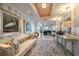 Inviting hallway with elegant décor, including paintings, a bench, and a stylish rug at 3 Seaside Ln # 601, Belleair, FL 33756