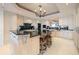 Kitchen island featuring black granite counters and bar stool seating at 3 Seaside Ln # 601, Belleair, FL 33756