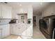 Bright laundry room with white cabinets and modern appliances at 3 Seaside Ln # 601, Belleair, FL 33756