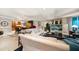 Bright living room with a dining area, white sofas, and an entertainment center at 3 Seaside Ln # 601, Belleair, FL 33756